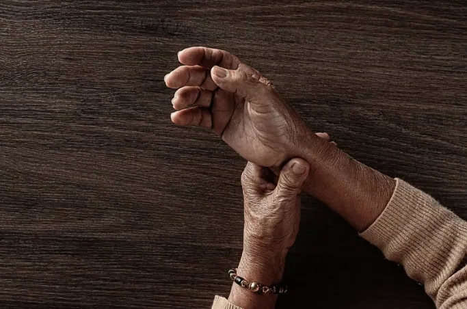 woman holding wrist with rheumatoid arthritis pain