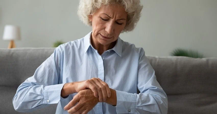 older woman holding her wrist