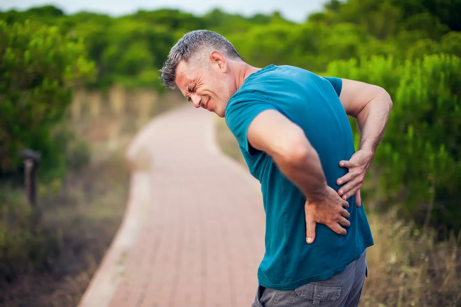 Man with back pain while exercising