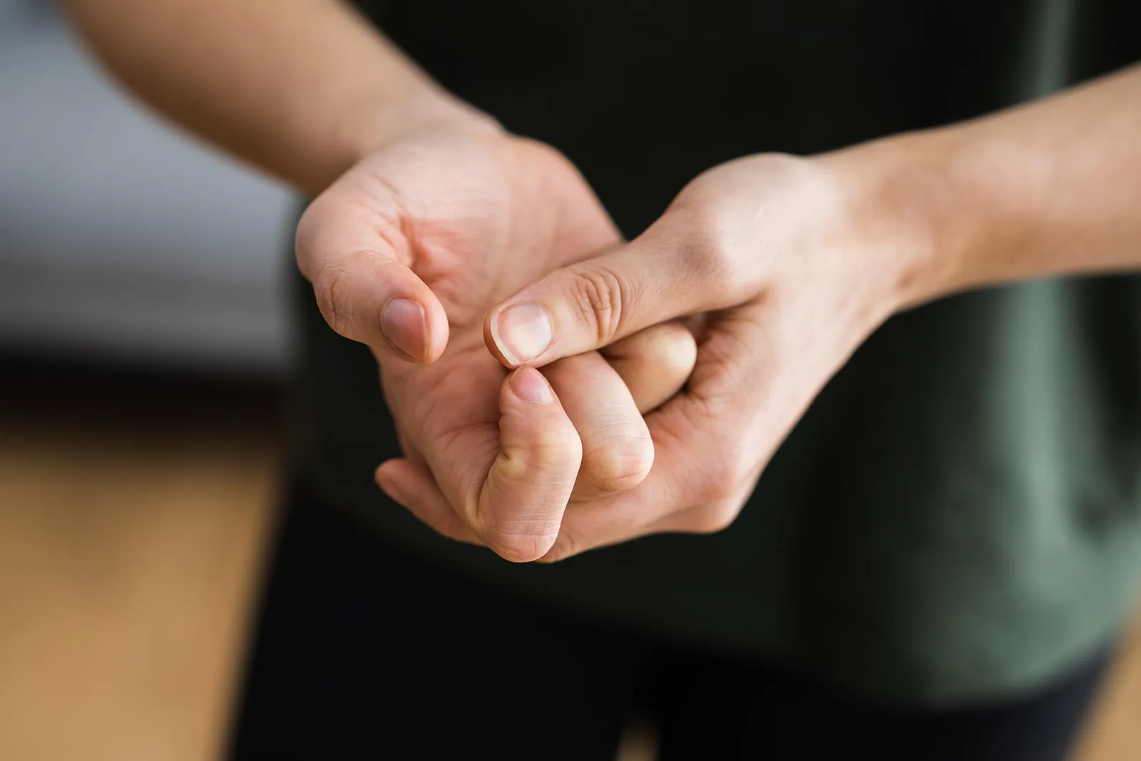 man holding hands cracking knuckles