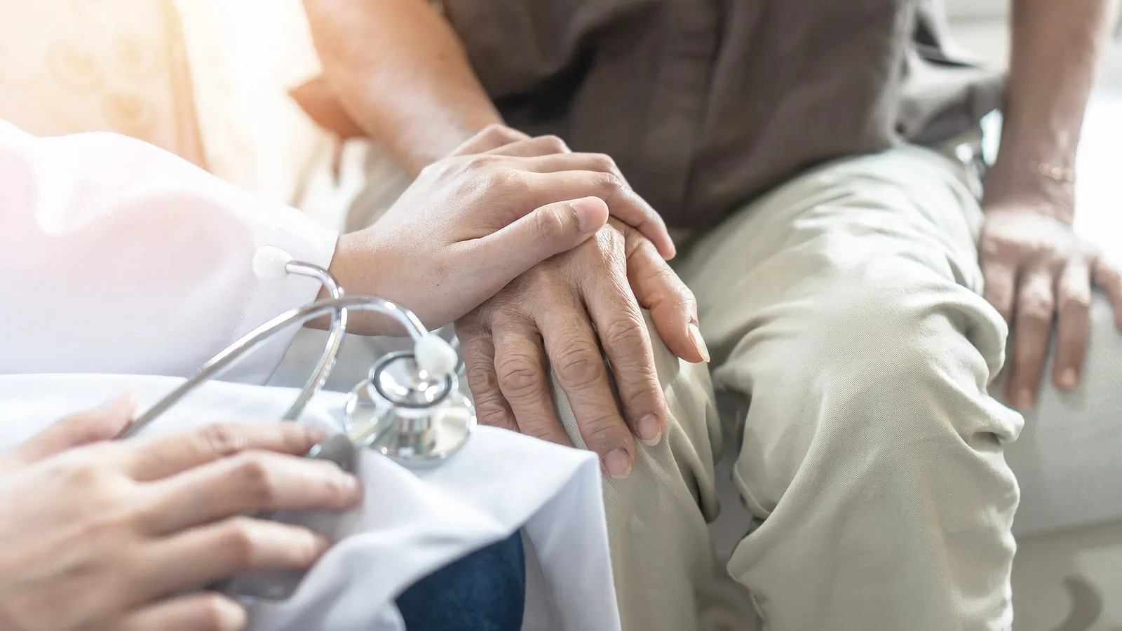 Arthritis person's hand in support of doctor