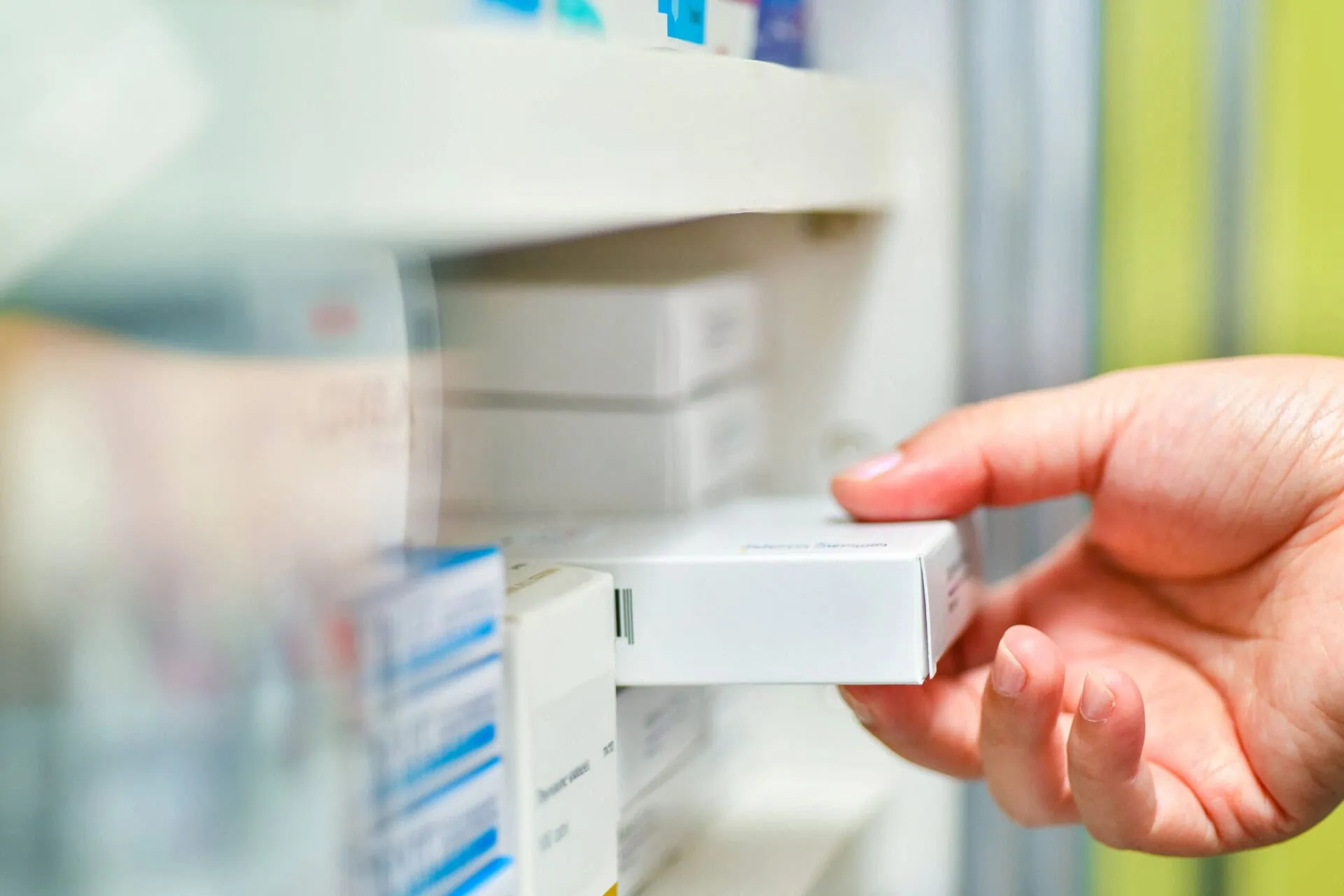 pharmacist-holding-medicine-box-in-pharmacy-store